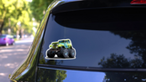 Green Cartoon Monster Truck Sticker on a Rear Car Window (New) example