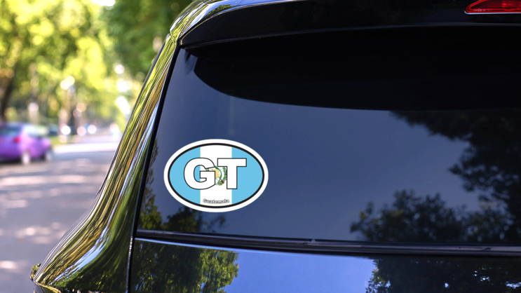 Guatemala Gt Flag Oval Sticker on a Rear Car Window (New) example