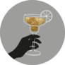Hand Holding Glitter Cocktail Glass With Citrus Sticker