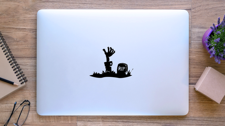 Hand Reaching From The Grave Sticker on a Laptop (New) example