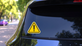 Hazard Warning Attention Sign Sticker on a Rear Car Window (New) example