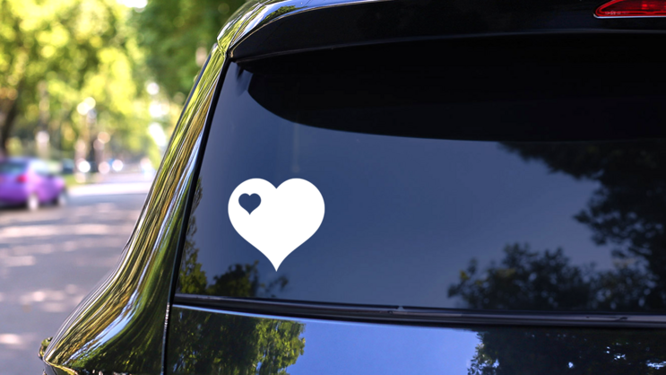 Heart With Little Heart Cut Out In Upper Left Corner Sticker on a Rear Car Window (New) example