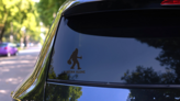 I Drink Alone Bigfoot Sticker on a Rear Car Window (New) example