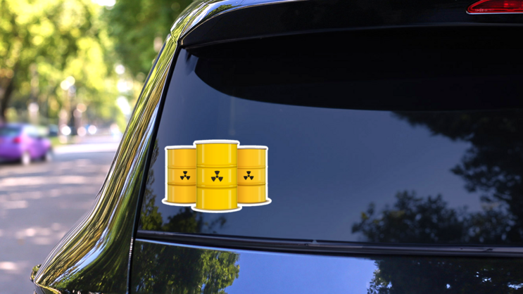 Illustration Of Yellow Metal Barrels With Nuclear Waste Sticker on a Rear Car Window (New) example