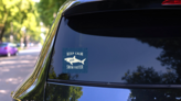 Keep Calm And Swim Faster Sticker on a Rear Car Window (New) example