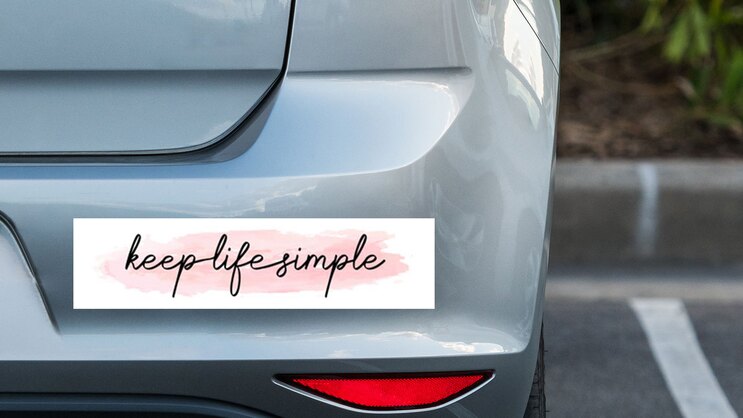 Keep Life Simple Bumper Sticker on a Grey Car Bumper example