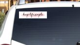 Keep Life Simple Bumper Sticker on a White Car Rear Window example