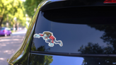 Leaping Cartoon Zombie Girl Sticker on a Rear Car Window (New) example