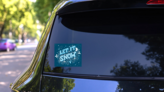 Let It Snow Retro Lettering Winter Sticker on a Rear Car Window (New) example