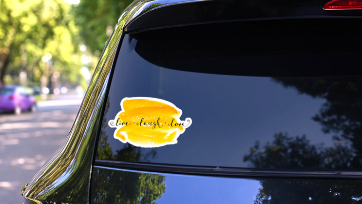live Laugh Love Lettering Calligraphy On Yellow Watercolor Sticker on a Rear Car Window (New) example