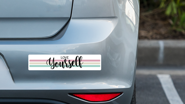 Love Yourself Bumper Sticker on a Grey Car Bumper example