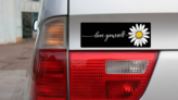 Love Yourself Daisy Bumper Sticker on a Gold Car Rear Bumper example