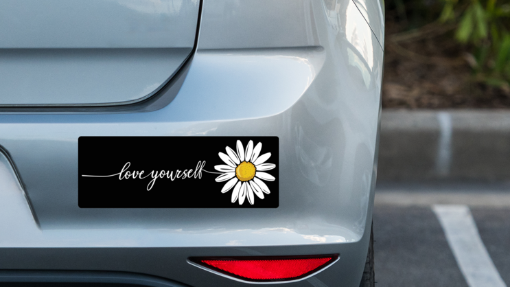 Love Yourself Daisy Bumper Sticker on a Grey Car Bumper example