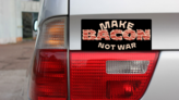 Make Bacon Not War Bumper Sticker on a Gold Car Rear Bumper example