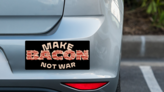 Make Bacon Not War Bumper Sticker on a Grey Car Bumper example