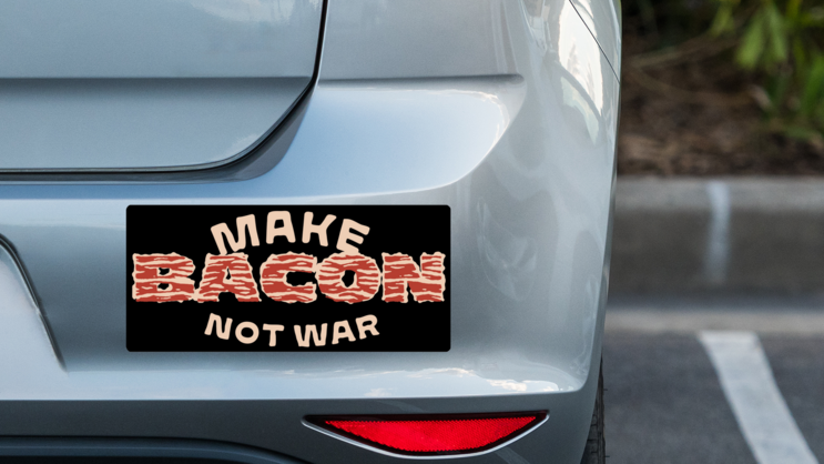 Make Bacon Not War Bumper Sticker on a Grey Car Bumper example
