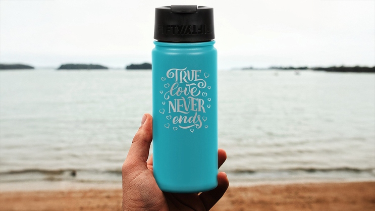Man holding custom engraved 16 oz water bottle