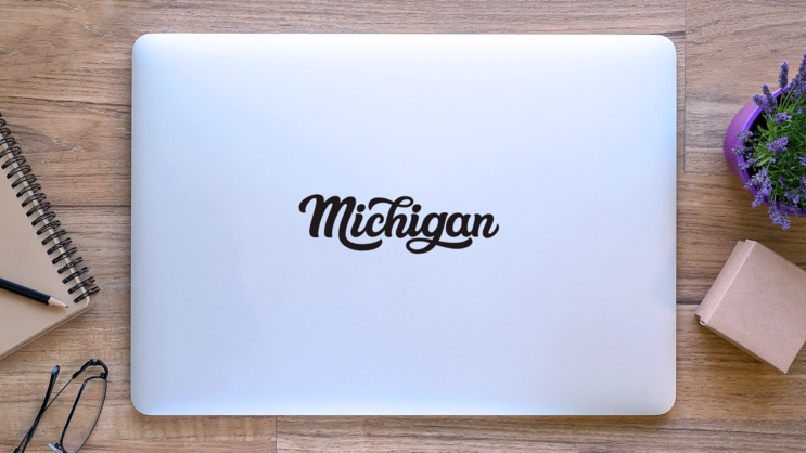 Michigan Calligraphy Sticker on a Laptop (New) example