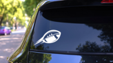 Modern Shaped Football With Swooshes Sticker on a Rear Car Window (New) example