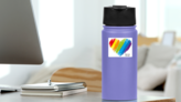 More Love Less Hate Rainbow Heart Sticker on a Water Bottle (New) example