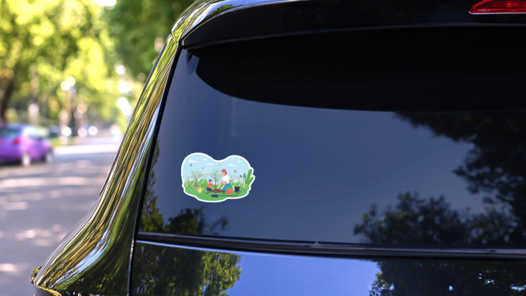 Mother And Son Planting Tree In Garden Sticker on a Rear Car Window (New) example