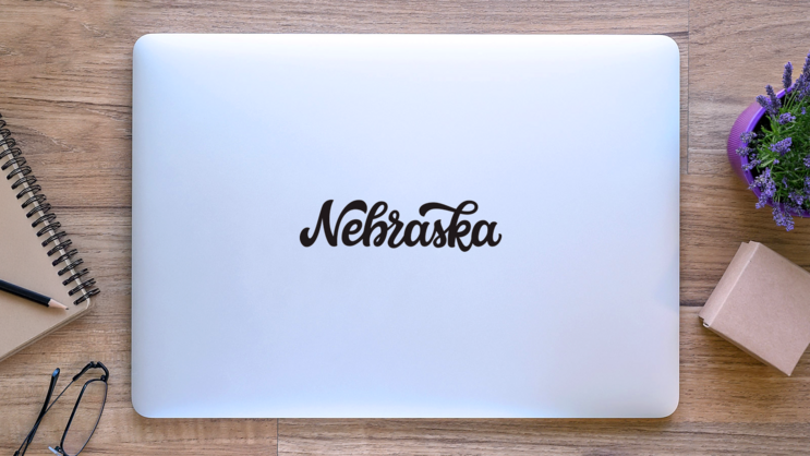Nebraska Calligraphy Sticker on a Laptop (New) example