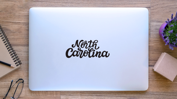 North Carolina Calligraphy Sticker on a Laptop (New) example