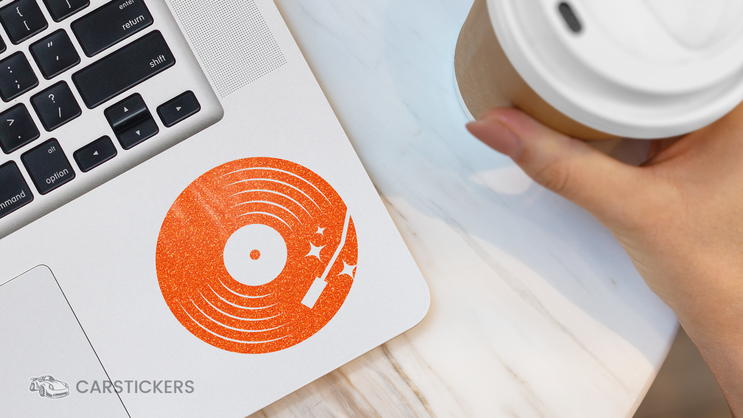 Orange Glitter Album Sticker On Laptop in Cafe