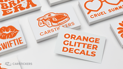 Taylor Swift themed orange glitter transfer decal stacks on tables.