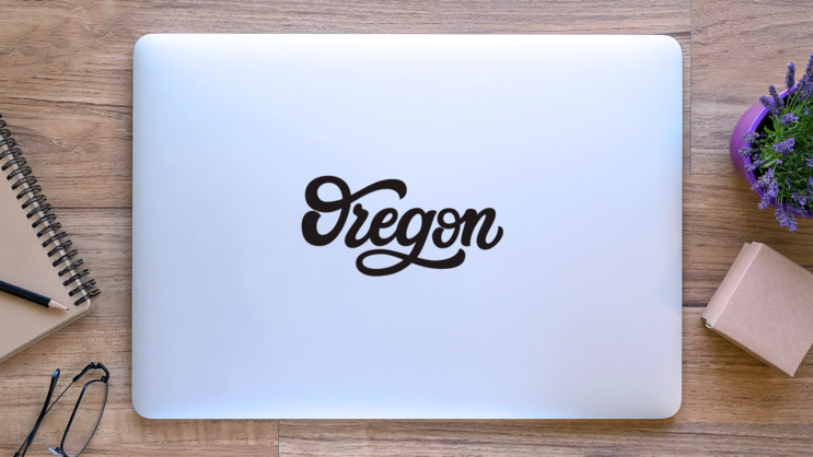 Oregon Calligraphy Sticker on a Laptop (New) example