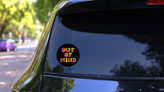 Out Of Mind Tie Dye Psychedelic Lettering On Black Sticker on a Rear Car Window (New) example