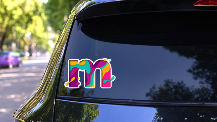 Paper Cut Lower Case Letter M Sticker on a Rear Car Window (New) example