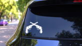 Pistol Guns Crossed Sticker on a Rear Car Window (New) example