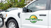 A printed transfer decal on the side of a landscape truck door.