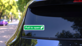 Pull To Open Sign Sticker on a Rear Car Window (New) example