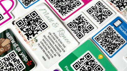 Custom QR Code Stickers in Stacks on a Table