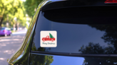 Red Truck With A Christmas Tree Sticker on a Rear Car Window (New) example