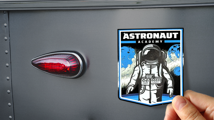 Applying a reflective background sticker to vehicle.