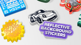 Stacks of sticker designs with a reflective background.