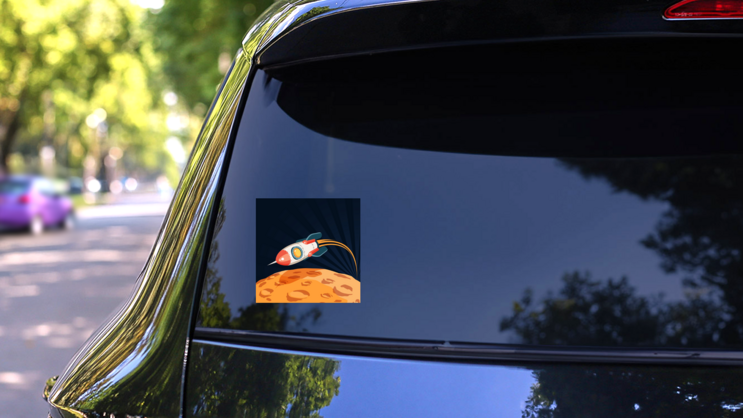 Rocket Flying Over the Moon Sticker on a Rear Car Window (New) example
