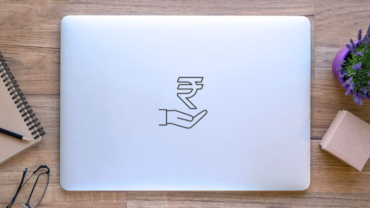 Rupee In Hand Sticker on a Laptop (New) example