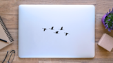 Silhouette Of Flying Flock Of Cranes Sticker on a Laptop (New) example
