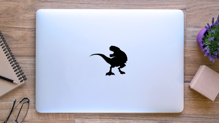 Silhouette T Rex Dinosaur Sticker on a Laptop (New) example