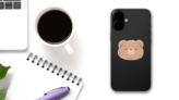 Smiling Teddy Bear Face Sticker on a Phone (New) example