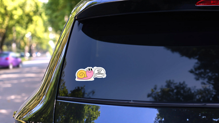 Snail Lets Get Started Sticker on a Rear Car Window (New) example