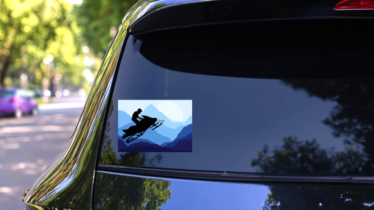 Snowmobile Rider In Nature Sticker on a Rear Car Window (New) example