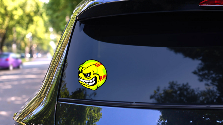 Softball With Angry Face Sticker on a Rear Car Window (New) example