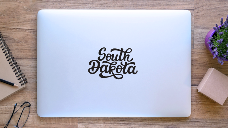 South Dakota Calligraphy Sticker on a Laptop (New) example