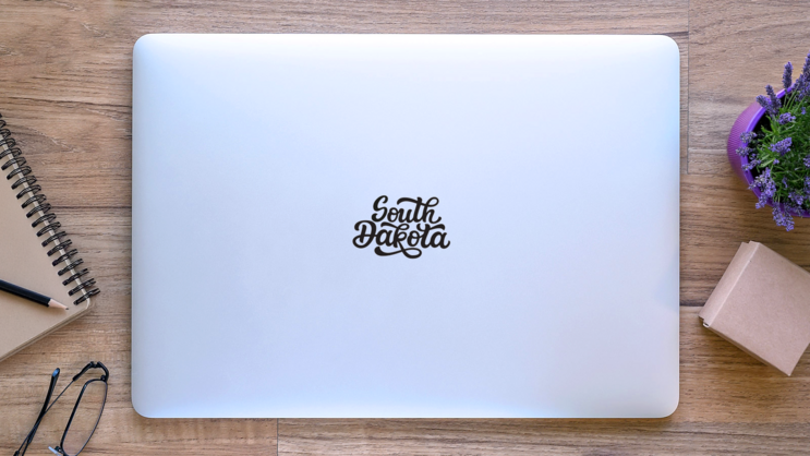 South Dakota. Hand Modern Calligraphy Sticker on a Laptop (New) example