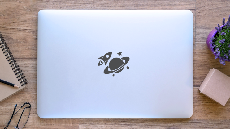 Spaceship Orbiting Saturn Sticker on a Laptop (New) example